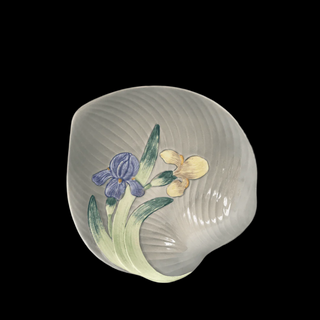 Decorative poreclain shallw bowl with floral iris design on a black background