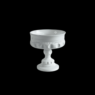 White decorative pedestal bowl on a black background