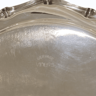 Close-up of a silver dish with 'Genuine Vinters' branding.