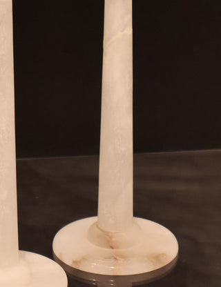 Snow White alabaster marble candle holder showing two cracks, one in the base which looks to be naturally occurirng and one on the neck that has been repaired