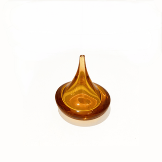 Amber-colored glass object on a white background