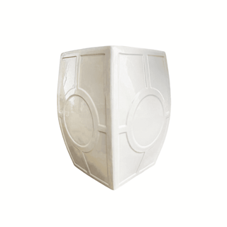 White decorative vase with circular patterns on a white background