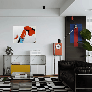 Modern living room with black leather sofa, abstract art, and stylish decor.