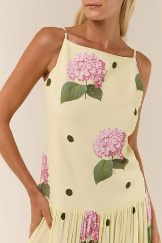Woman wearing a dress with floral design on a beige background
