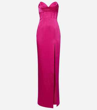 A bright fuchsia pink strapless gown with a sweetheart neckline, structured waist, and a high front slit, shown against a light gray background.