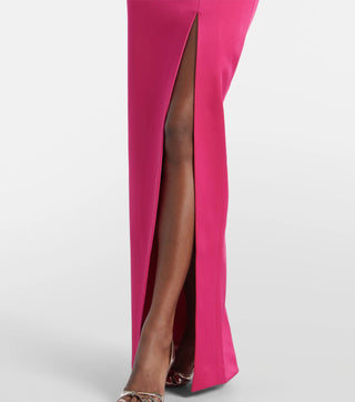 Close-up of a bright pink dress with a high slit on a white background