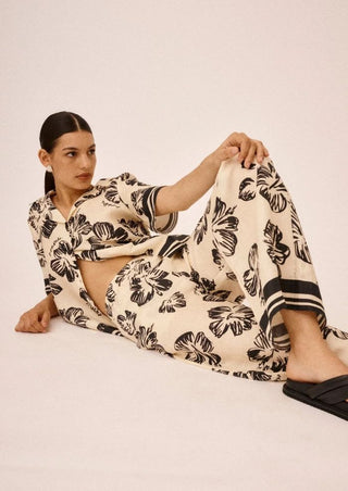Roame Cruz Shirt And Ascend Pant in Hibiscus Sunrise Renascence Studio  LAYING DOWN SET IMAGE